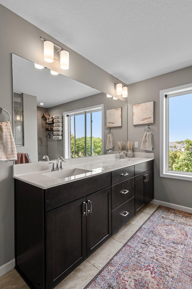 14834 Willemite Way NW, Ramsey, MN 55303 - full bath with double vanity, baseboards, tile patterned floors, and a textured ceiling