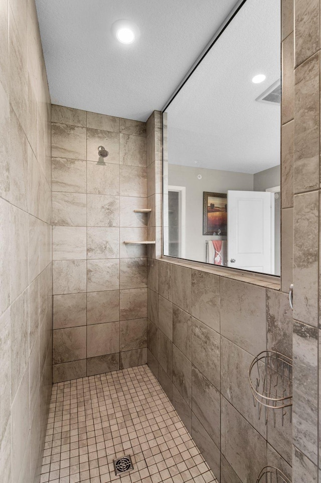 14834 Willemite Way NW, Ramsey, MN 55303 - full bathroom featuring a tile shower, a textured ceiling, and recessed lighting