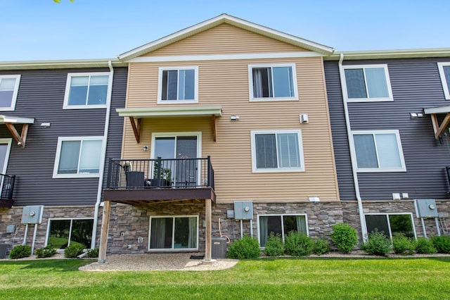 14834 Willemite Way NW, Ramsey, MN 55303 - rear view of house with stone siding, a yard, cooling unit, and a balcony