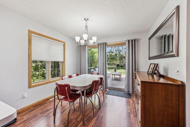 901 14th St N, Sartell, MN 56377 - dining space with a chandelier, dark wood-style flooring, and a textured ceiling