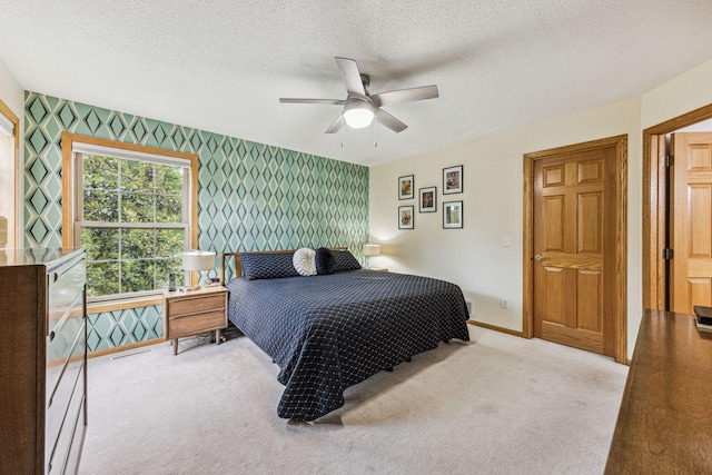 901 14th St N, Sartell, MN 56377 - carpeted bedroom featuring wallpapered walls, an accent wall, a textured ceiling, and ceiling fan