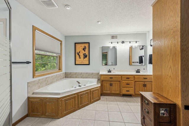 901 14th St N, Sartell, MN 56377 - bathroom with a bath, double vanity, tile patterned floors, and a textured ceiling