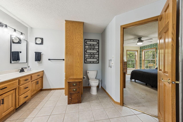 901 14th St N, Sartell, MN 56377 - bathroom with a textured ceiling, vanity, connected bathroom, tile patterned floors, and ceiling fan