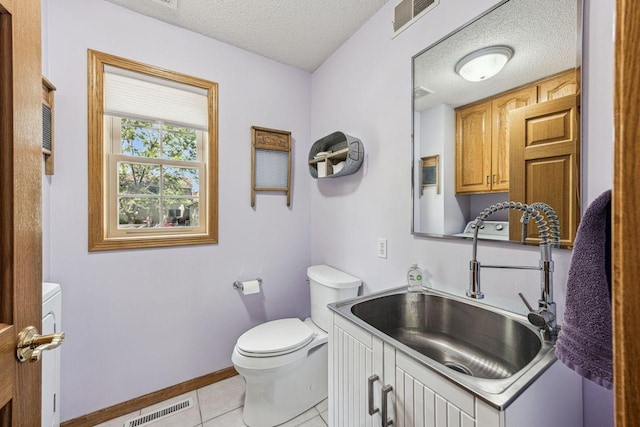 901 14th St N, Sartell, MN 56377 - half bathroom featuring a textured ceiling, tile patterned floors, and vanity