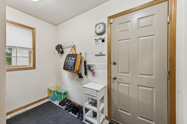 901 14th St N, Sartell, MN 56377 - mudroom featuring a textured ceiling and baseboards
