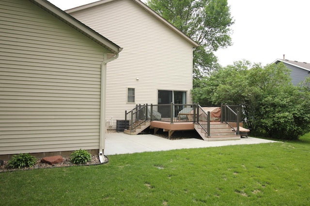 901 14th St N, Sartell, MN 56377 - rear view of house with a patio, a lawn, and a wooden deck