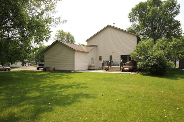 901 14th St N, Sartell, MN 56377 - rear view of property with a deck and a lawn