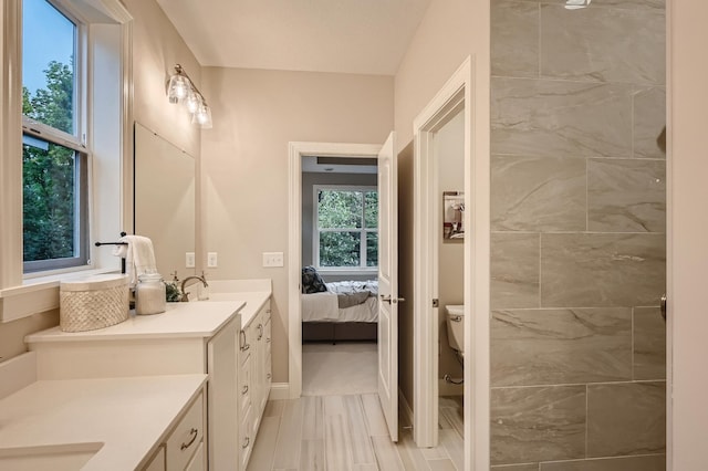5054 Dale Ridge Rd, Woodbury, MN 55129 - full bath with vanity, toilet, connected bathroom, and baseboards