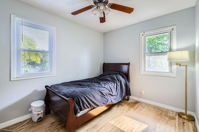 7724 Major Ave N, Brooklyn Park, MN 55443 - bedroom featuring baseboards, wood finished floors, and ceiling fan