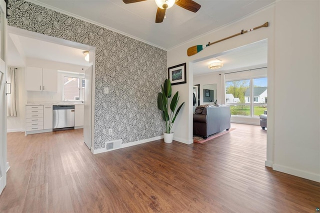 2508 Springvale Rd, Duluth, MN 55811 - spare room featuring a ceiling fan, light wood-style flooring, baseboards, an accent wall, and ornamental molding