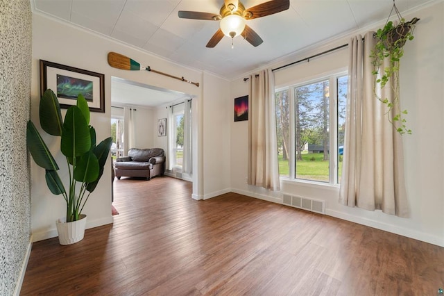 2508 Springvale Rd, Duluth, MN 55811 - spare room featuring wood finished floors, crown molding, ceiling fan, and baseboards