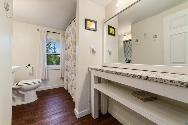2508 Springvale Rd, Duluth, MN 55811 - full bathroom featuring toilet, wood finished floors, vanity, baseboards, and lofted ceiling