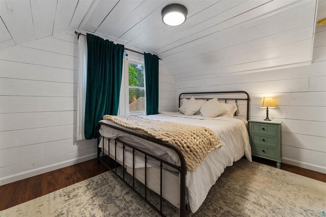 2508 Springvale Rd, Duluth, MN 55811 - bedroom with baseboards, lofted ceiling, dark wood-style flooring, and wooden walls