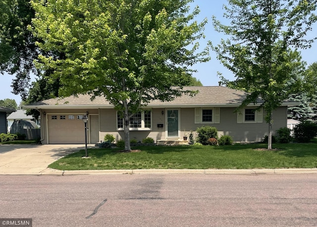 705 Turril St, Le Sueur, MN 56058 - ranch-style home with concrete driveway, an attached garage, and a front lawn