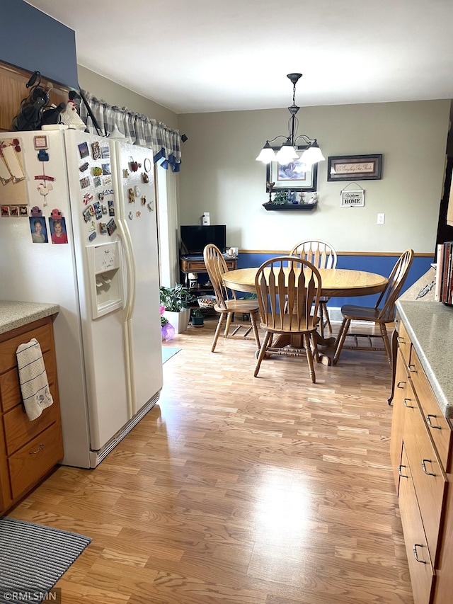 705 Turril St, Le Sueur, MN 56058 - dining space with light wood finished floors and a chandelier