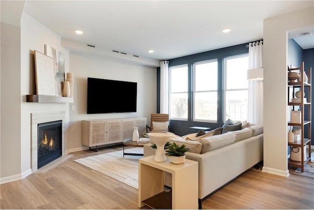 1727 Hauer Trl, Shakopee, MN 55379 - living room with light wood-type flooring, a glass covered fireplace, and recessed lighting