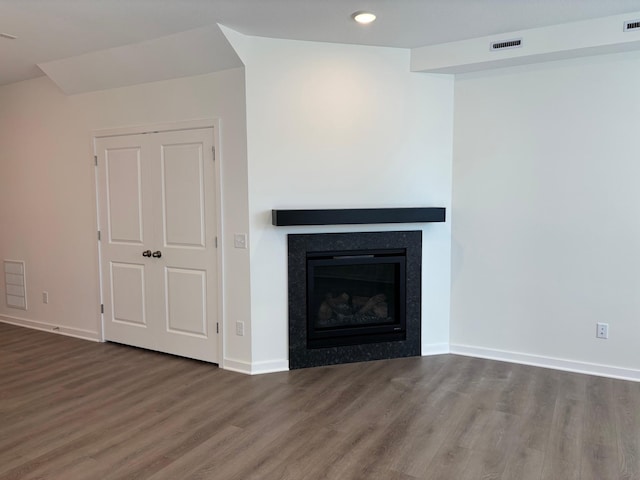 1727 Hauer Trl, Shakopee, MN 55379 - unfurnished living room with wood finished floors, a glass covered fireplace, and recessed lighting