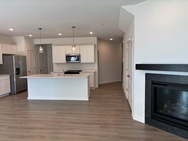 1727 Hauer Trl, Shakopee, MN 55379 - kitchen with appliances with stainless steel finishes, white cabinetry, light countertops, recessed lighting, and wood finished floors