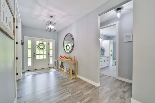16460 Sanctuary Way, Brainerd, MN 56401 - entrance foyer featuring light wood-style floors, a chandelier, and baseboards