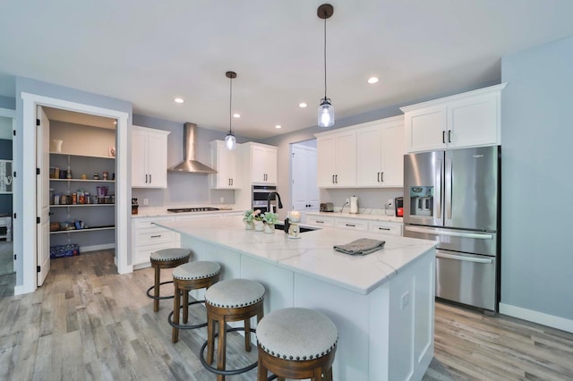 16460 Sanctuary Way, Brainerd, MN 56401 - kitchen with stainless steel appliances, wall chimney range hood, a sink, light wood-style floors, and recessed lighting