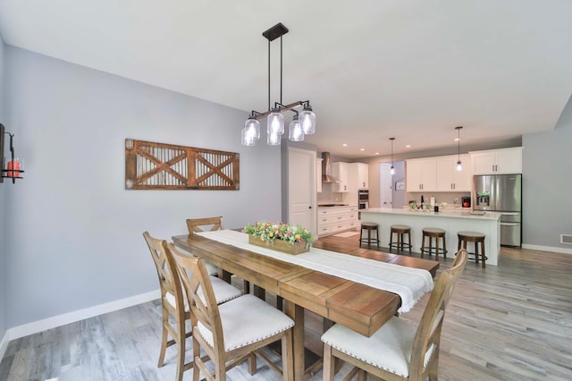 16460 Sanctuary Way, Brainerd, MN 56401 - dining area with baseboards, light wood finished floors, and recessed lighting