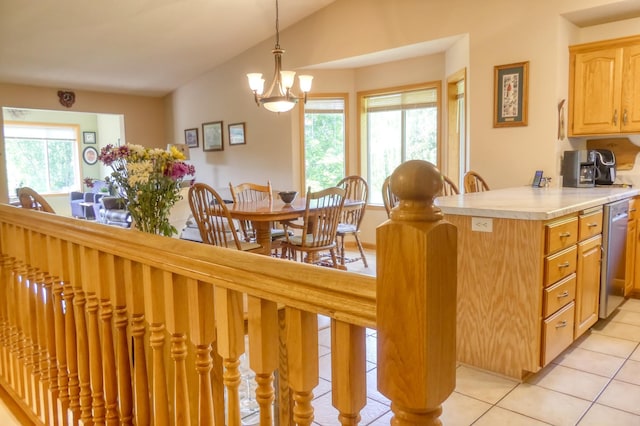 735 Highview Ct, Saint Croix Falls, WI 54024 - kitchen with stainless steel dishwasher, light tile patterned floors, plenty of natural light, light countertops, and lofted ceiling