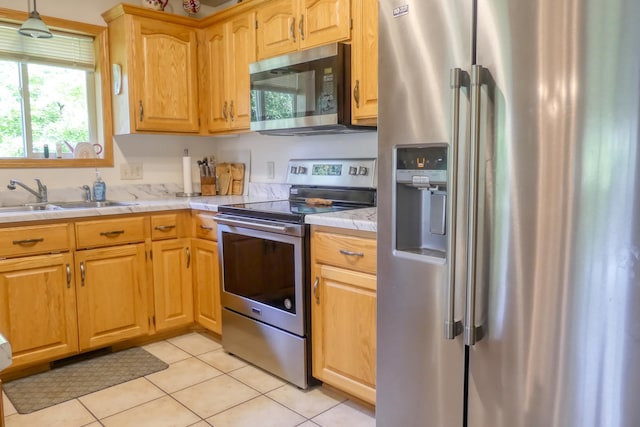 735 Highview Ct, Saint Croix Falls, WI 54024 - kitchen with appliances with stainless steel finishes, light countertops, light tile patterned flooring, and hanging light fixtures