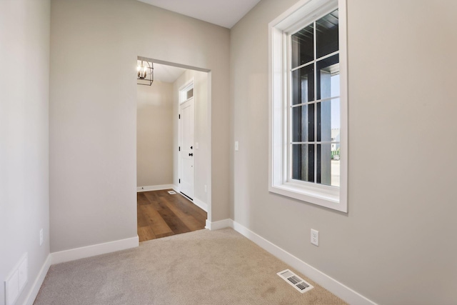 6135 Harkness Ln S, Cottage Grove, MN 55016 - unfurnished room featuring a chandelier and carpet flooring