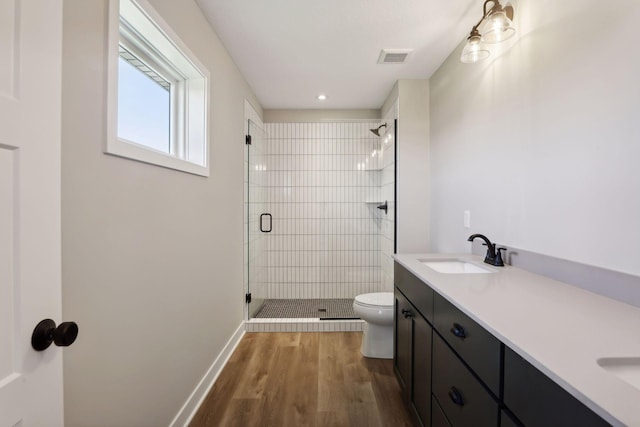 6135 Harkness Ln S, Cottage Grove, MN 55016 - bathroom with a stall shower, double vanity, and wood finished floors