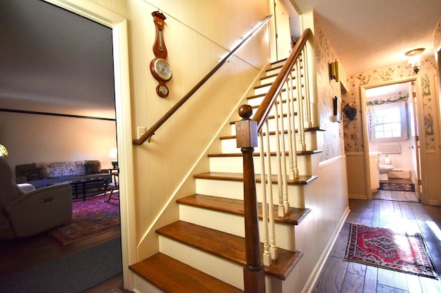 2645 Riverside Ln NE, Rochester, MN 55906 - stairway with hardwood / wood-style flooring, wallpapered walls, and baseboards