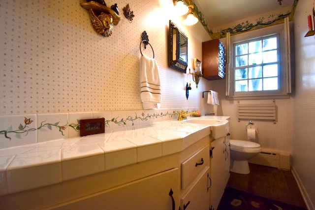 2645 Riverside Ln NE, Rochester, MN 55906 - bathroom featuring baseboard heating, toilet, and vanity