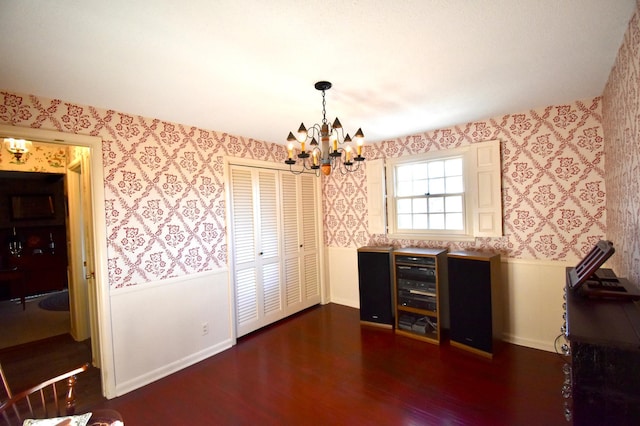 2645 Riverside Ln NE, Rochester, MN 55906 - unfurnished dining area with wallpapered walls, a chandelier, dark wood finished floors, baseboards, and a wainscoted wall