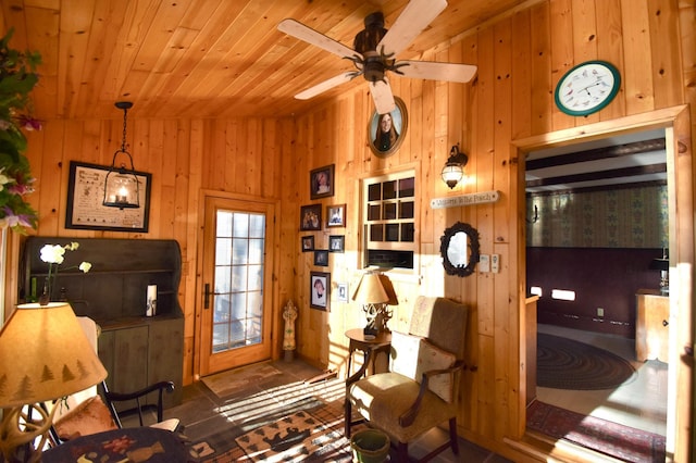 2645 Riverside Ln NE, Rochester, MN 55906 - living area with wood walls, wood ceiling, and a ceiling fan