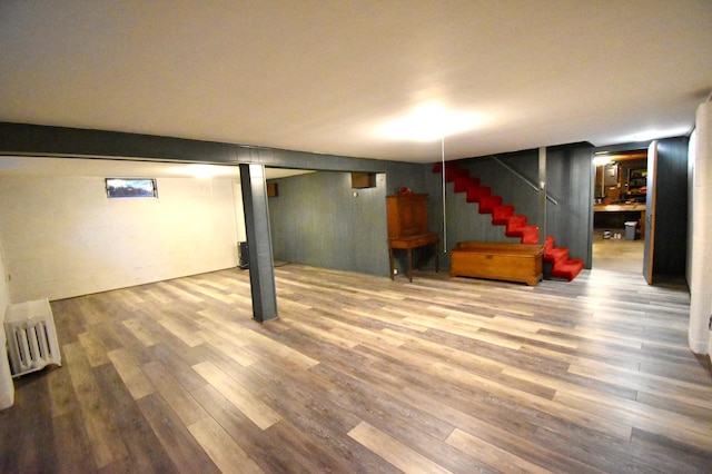 2645 Riverside Ln NE, Rochester, MN 55906 - finished basement featuring radiator, wood finished floors, and stairs