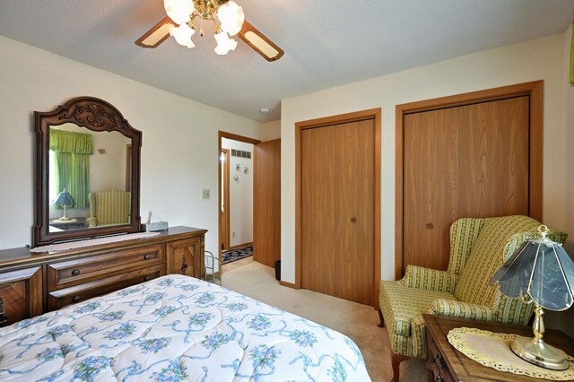 27681 Moser Dr, Jackson Twp, WI 54893 - bedroom featuring light carpet, multiple closets, and ceiling fan