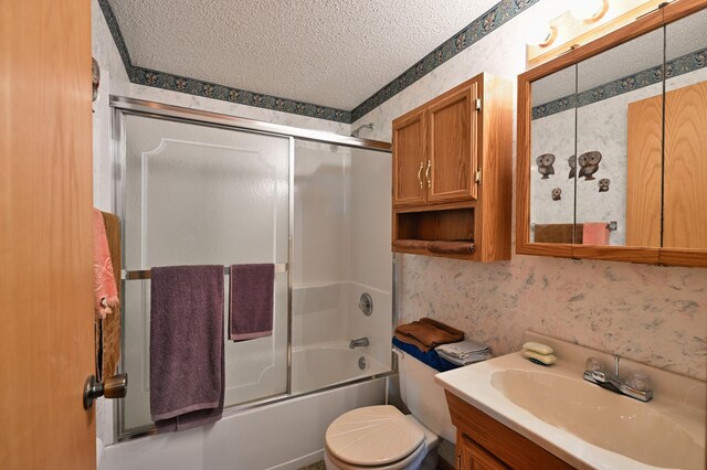 27681 Moser Dr, Jackson Twp, WI 54893 - full bath with a textured ceiling, wallpapered walls, vanity, toilet, and enclosed tub / shower combo