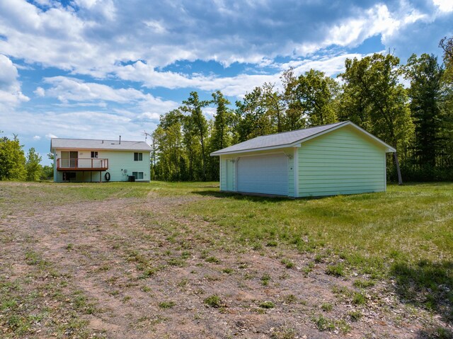 27681 Moser Dr, Jackson Twp, WI 54893 - view of green lawn featuring a garage, an outbuilding, and a deck