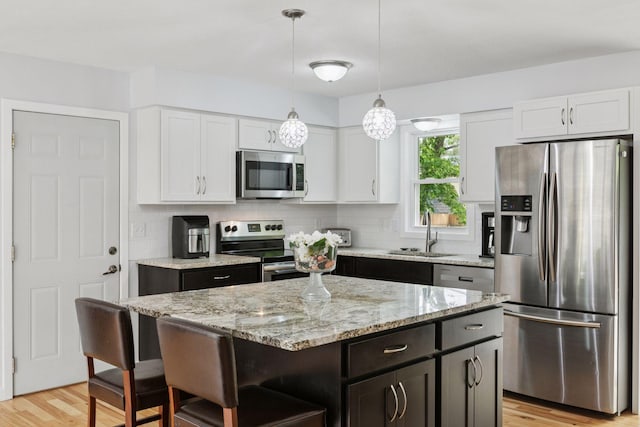 265 107th Ln NW, Coon Rapids, MN 55448 - kitchen featuring appliances with stainless steel finishes, a sink, and white cabinets