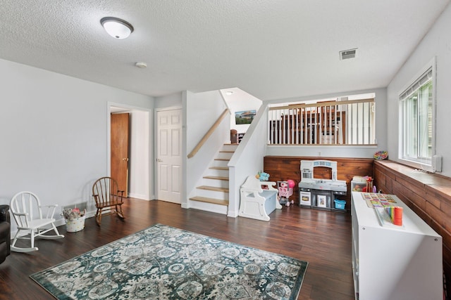 265 107th Ln NW, Coon Rapids, MN 55448 - living room featuring wood finished floors, stairs, a textured ceiling, and baseboards