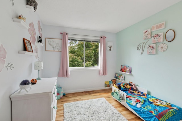 265 107th Ln NW, Coon Rapids, MN 55448 - bedroom featuring wood finished floors and baseboards