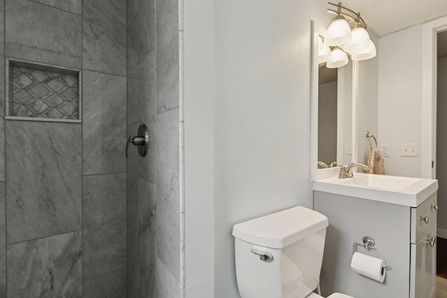 265 107th Ln NW, Coon Rapids, MN 55448 - bathroom with toilet, vanity, and a tile shower