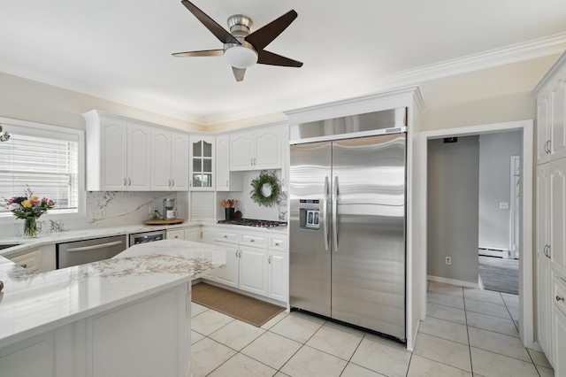 5035 Wren Rd, Mound, MN 55364 - kitchen with stainless steel appliances, a baseboard radiator, ornamental molding, backsplash, and light stone counters