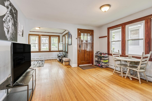 1167 Geranium Ave E, Saint Paul, MN 55106 - entrance foyer with arched walkways, light wood-style floors, a baseboard radiator, and baseboards