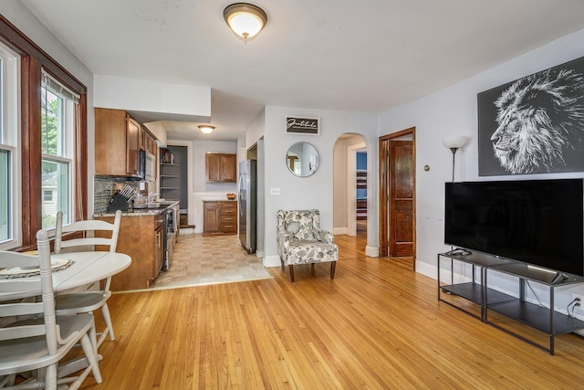 1167 Geranium Ave E, Saint Paul, MN 55106 - living area with arched walkways, light wood-type flooring, and baseboards