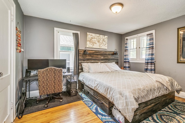 1167 Geranium Ave E, Saint Paul, MN 55106 - bedroom featuring hardwood / wood-style flooring, multiple windows, a textured ceiling, and a desk