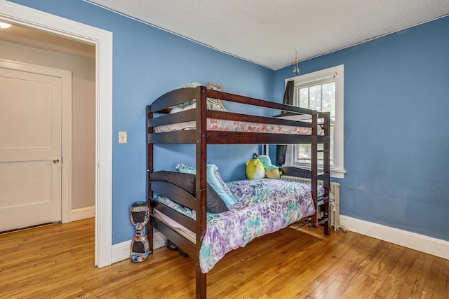 1167 Geranium Ave E, Saint Paul, MN 55106 - bedroom with hardwood / wood-style flooring, baseboards, and a textured ceiling