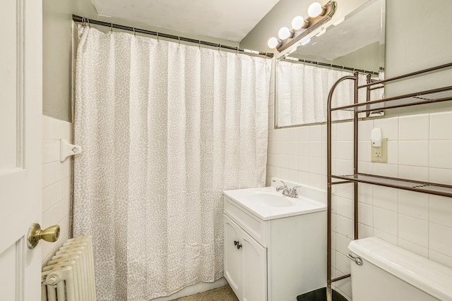 1167 Geranium Ave E, Saint Paul, MN 55106 - bathroom featuring tile walls, radiator, vanity, toilet, and a shower with shower curtain
