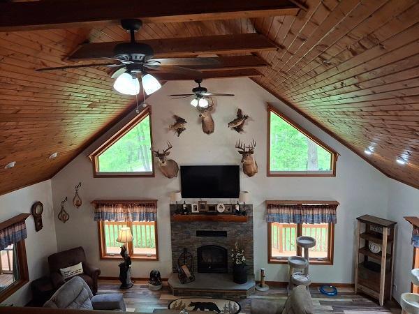 29805 Arbo Rd, Grand Rapids, MN 55744 - living room with wooden ceiling, lofted ceiling, ceiling fan, a fireplace, and wood finished floors