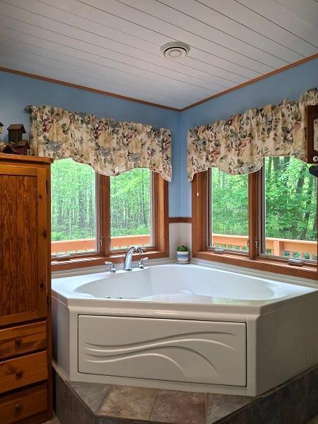 29805 Arbo Rd, Grand Rapids, MN 55744 - full bath featuring plenty of natural light, a garden tub, wooden ceiling, and crown molding
