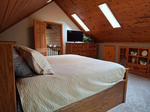 29805 Arbo Rd, Grand Rapids, MN 55744 - bedroom featuring a skylight, light colored carpet, lofted ceiling, and wooden ceiling